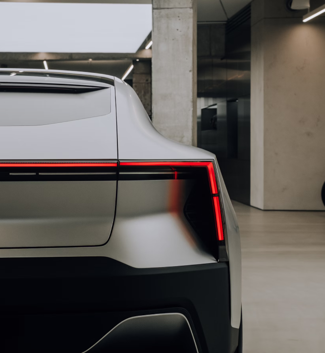 Image of a car parked in a dealership taken from the back.