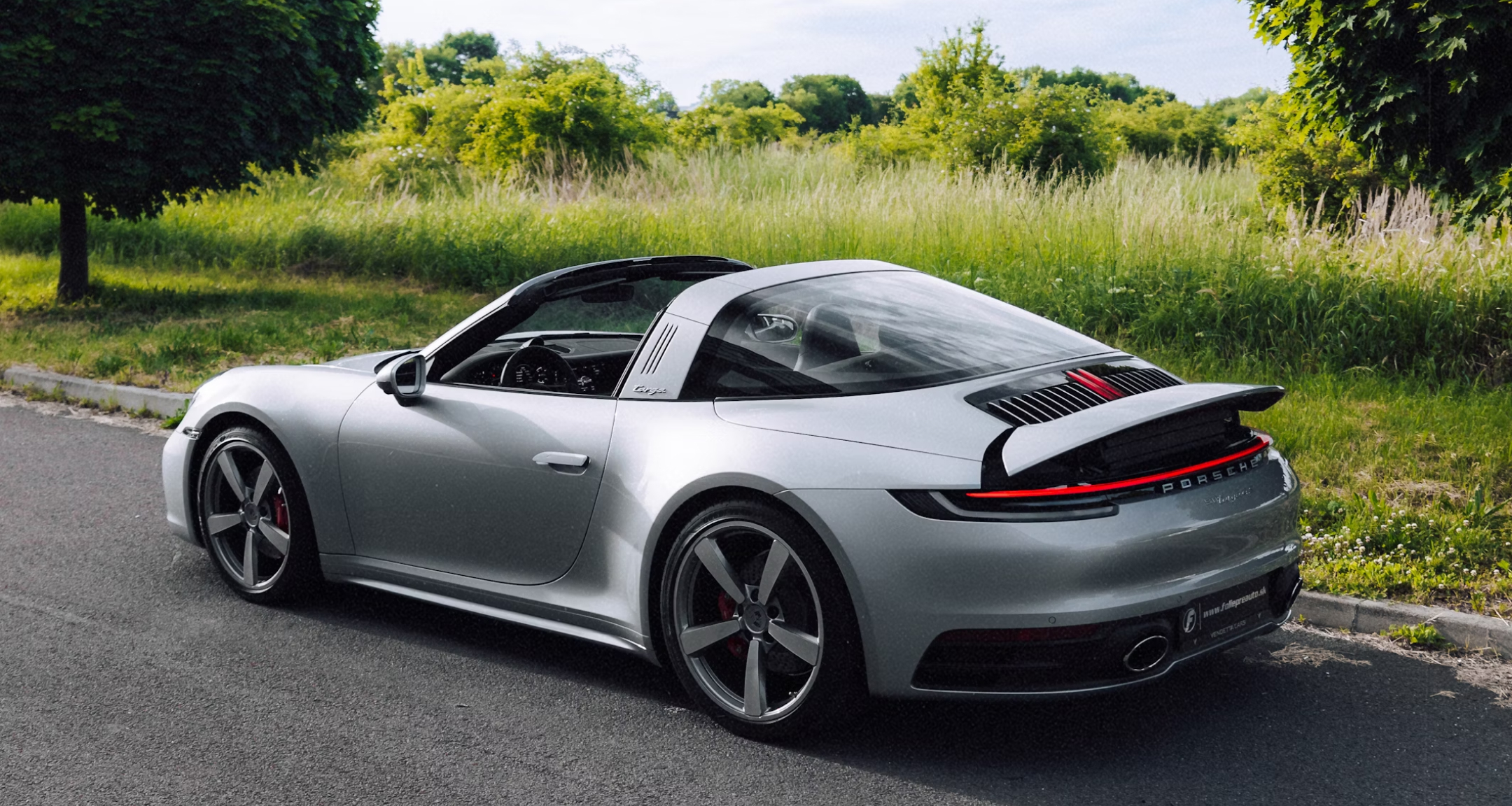 Image of a parked gray Porsche.