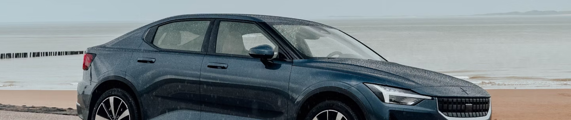 Image of a car driving on the beach.