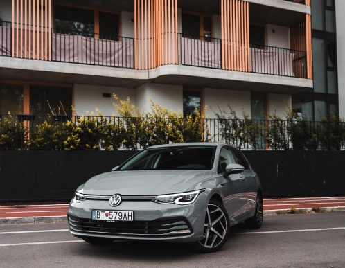 Image of a grey parked car taken from the front.